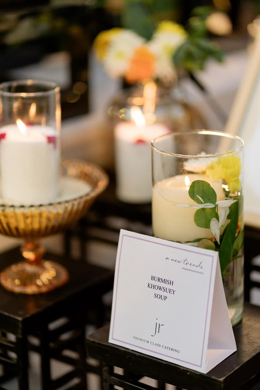 Candlelit dessert and menu card styling at a private celebration catering setup