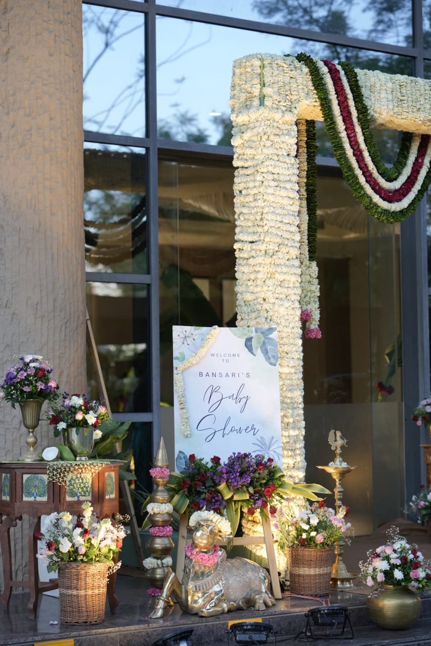 Floral garland entrance styling for a private baby shower