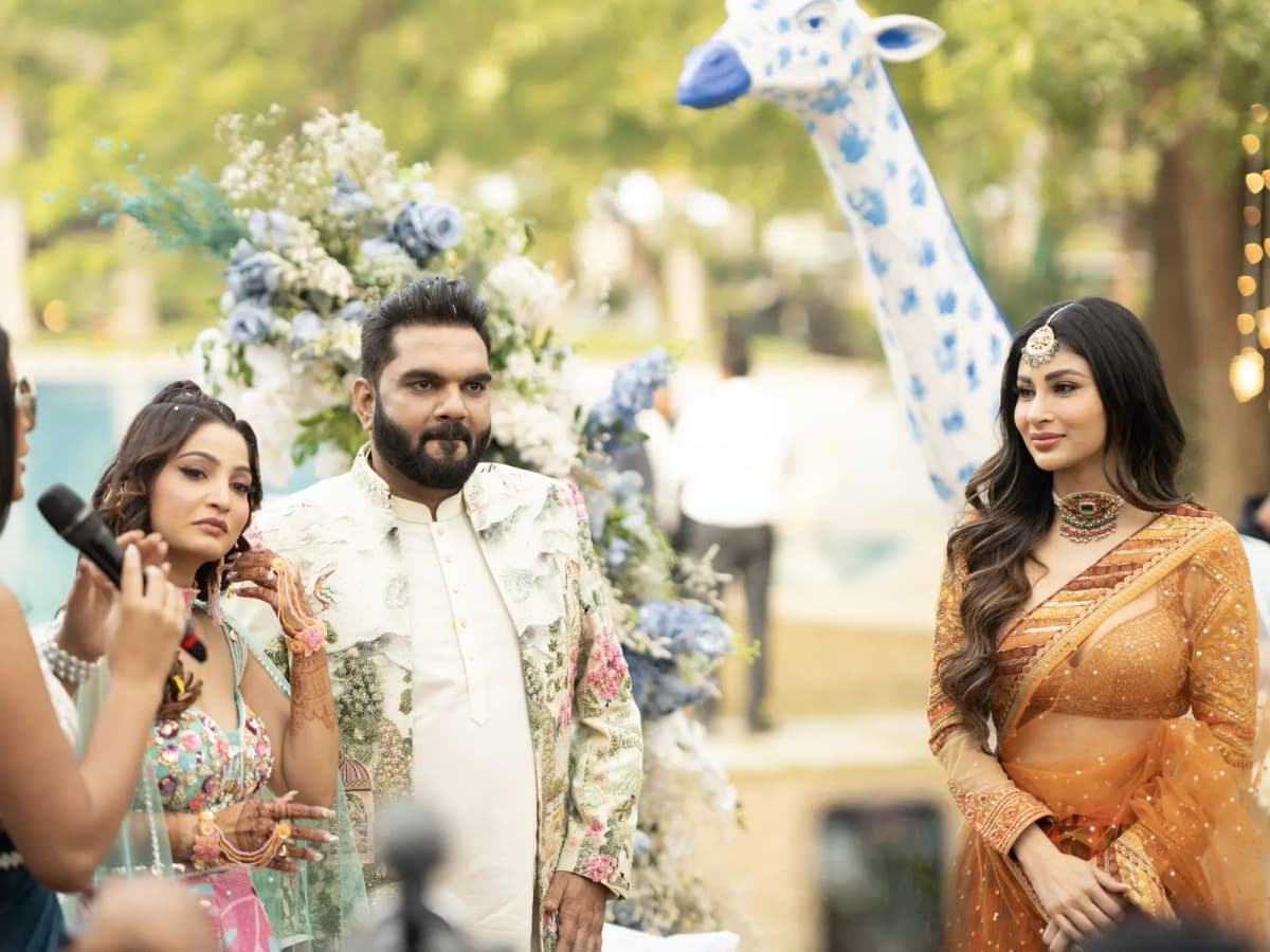 Couple posing at a whimsically decorated celebration