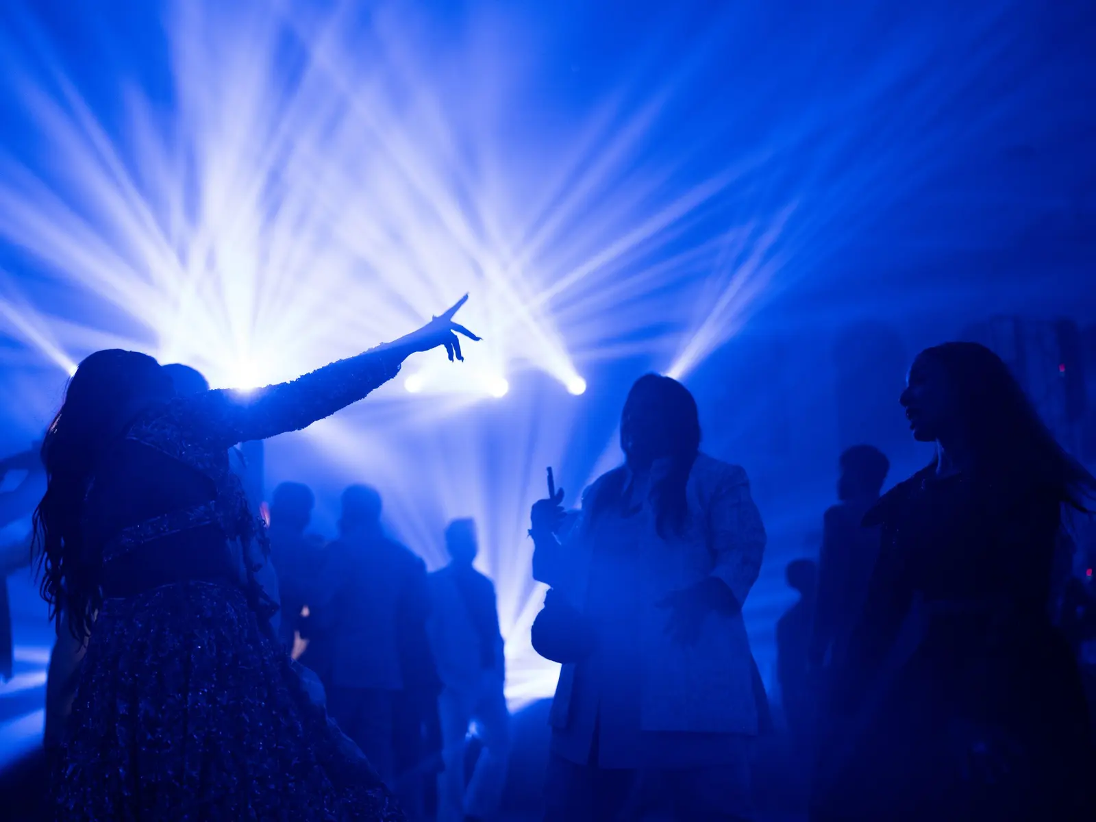 Crowd energy under dramatic lighting at a corporate event