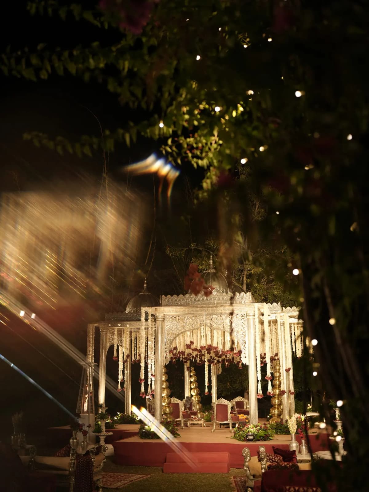 Illuminated wedding mandap at night